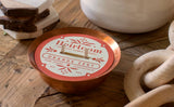 Copper Kettle Soy Candle with orange and white Heirloom Orange Zest label.