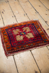 Corner close-up of vintage Oushak rug showing serrated floral and vine motifs in cherry red, beige, sapphire blue.