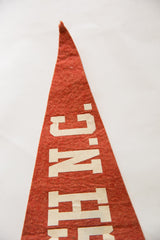 Detail of the off-white 'N.C.' lettering on the vintage Raleigh NC felt flag.