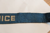 Vintage felt banner showing blue fabric texture with subtle creasing and a small pinhole.