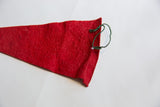 Textured red felt of the vintage flag with green hanging cord.