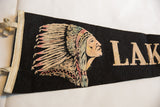 Close-up of vintage black felt flag, Native American graphic with pastel feathered headdress.