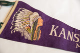 Vintage Kansas City felt flag close-up of bound edge, green tie, and chief graphic on purple.