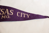 Vintage Kansas City felt flag, purple with pointed tip and beige 'CITY' lettering.