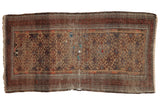 Antique Belouch rug, geometric pattern in camel, madder, aubergine, showing age-related character, 2'10