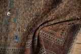 Antique Belouch rug border detail with pawn motif, meandering vine, and visible storied repairs.