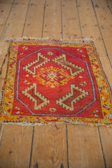 Vintage Oushak rug corner showing geometric border, serrated leaves, and tattered fringe.