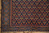 Vintage Afshar rug corner: germinating floral field, serpent border, tattered end.
