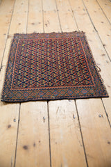 Persian Afshar tribal rug showing rich madder root field, serpent border, and tattered lower edge.