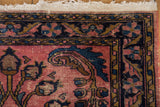 Lilihan rug corner with fringe, wear to knot heads, and oversized serrated scrolling leaves.