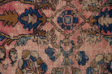 Vintage Lilihan rug detail showing wear to foundation, raspberry red, cobalt blue pile.