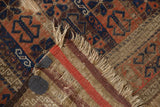 Antique Belouch rug's madder root and navy pile, showing striped reverse with canvas reinforcement.