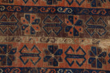Unusual germinating plants and serpent motifs in madder root and navy on antique Belouch rug.
