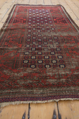 Ivory fringe and distressed madder root, navy, chocolate brown border of antique Belouch runner.