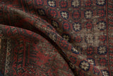 Close-up of antique Belouch runner's deep red, navy, brown weave, showing wear and foundation.