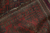 Antique Belouch runner's deep red and brown repeating motifs, with foundation wear.