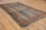 Storied pile and tattered fringe on this antique Malayer rug, with Herati and vine patterns.