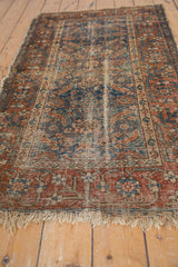 Antique Malayer rug: tattered fringe, worn foundation, and traditional madder-navy patterns.