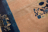 Abrashed pale peach field with exposed foundation and indigo floral border.