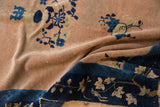 Peking rug's indigo blue border with pale coffee brown sprawling vines and oversized leaves.