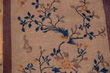 Vintage Nichols Art Deco rug detail: cobalt blue bird and sprawling vinery on beige, with mauve border.