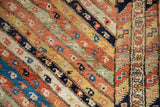 Detailed view of diagonal ribboned borders with inline botehs on an antique Persian Kurdish collector rug.