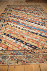 Low angle view of an antique Kurdish runner's colorful, diagonally striped boteh pattern.