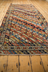 Foreshortened view of a late 19th-century Kurdish runner's parallel ribboned design and borders.