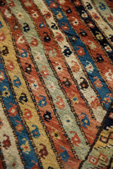 Hand-knotted pile texture of an antique Kurdish rug with inline botehs in ribboned borders.