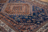 Antique Persian Afshar rug's indigo and chestnut brown geometric motifs with even pile wear.