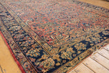 Vintage Lilihan carpet corner, expressive floral patterns in dusty raspberry and navy.