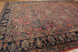 Hand-knotted Lilihan rug detail: navy border, dusty raspberry field, and unique sprawling floral designs.