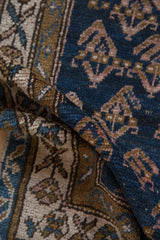 Antique Kurdish rug, hand-knotted pile with abrash ground, navy, bronze, ivory boteh.