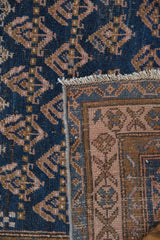 Antique Kurdish rug edge showing white fringe, secure side, and patterned reverse.
