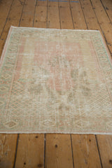 Distressed Oushak rug pile showing pale blush, mint green, and coffee brown tones with foundation wear.