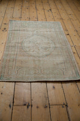 Distressed vintage Oushak rug pile, showing even wear, faint foundation, and muted hues.