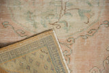 Distressed vintage Oushak rug corner, showing worn pile and hand-knotted back construction.