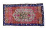 Hand-knotted vintage distressed Oushak rug with lozenge medallion, playful florals in pink, cochineal red, royal blue.