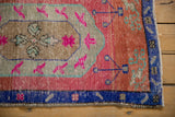 Distressed royal blue border, vibrant pink field, and playful motifs of vintage Oushak.