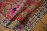 Distressed Oushak rug mat's worn pile, geometric border with fuchsia and brown, short fringe.