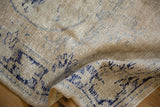 Distressed Oushak rug showing textured pile, mostly even wear, and faded cobalt blue.