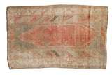 Distressed vintage Oushak rug featuring a dusty raspberry field and seafoam green motifs.