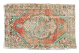 Distressed vintage Oushak rug mat, floral medallion on abrashed blush, seafoam, ivory field.
