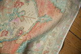 Soft, distressed texture of vintage Oushak rug, with mottled blush, seafoam, and ivory tones.