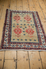 Vintage Distressed Oushak rug corner with geometric navy, red border and secured selvage.