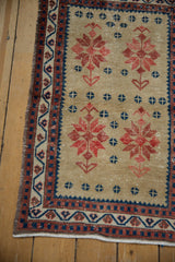 Distressed Oushak rug texture, with geometric starbursts in caramel, navy, and brick red.