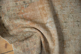 Distressed vintage Oushak runner's textured pile, with mellow apricot and antique ivory shades.
