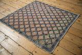 Distressed Oushak rug corner with cobalt blue serpent border, abashed brown to green floral field.