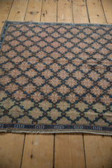 Distressed Oushak rug detail: worn texture, beige to mint green fade, and blue border.