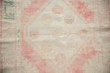 Faded blush and beige pile texture on a distressed vintage Oushak runner.
